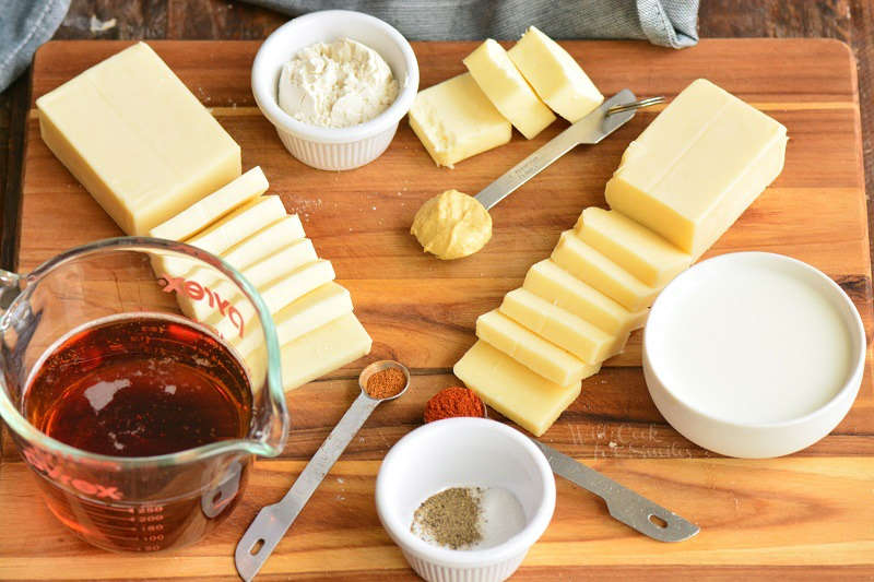 ingredients for beer cheese dip on the cutting board. 