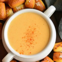 top view of beer cheese dip surrounded by pretzel bites.