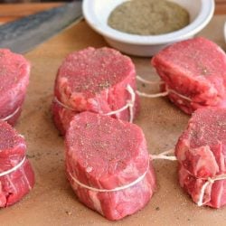 Filer Mignon with twin tied around them and salt and pepper in a bowl.