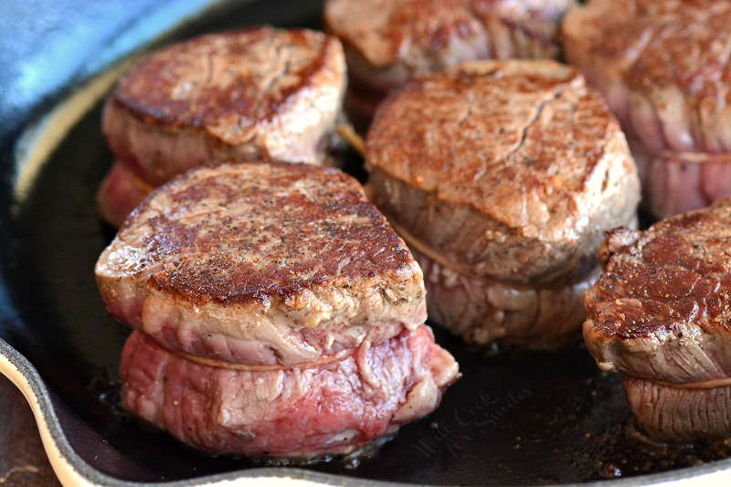 horizonal filet mignon with in a cast iron skillet. 
