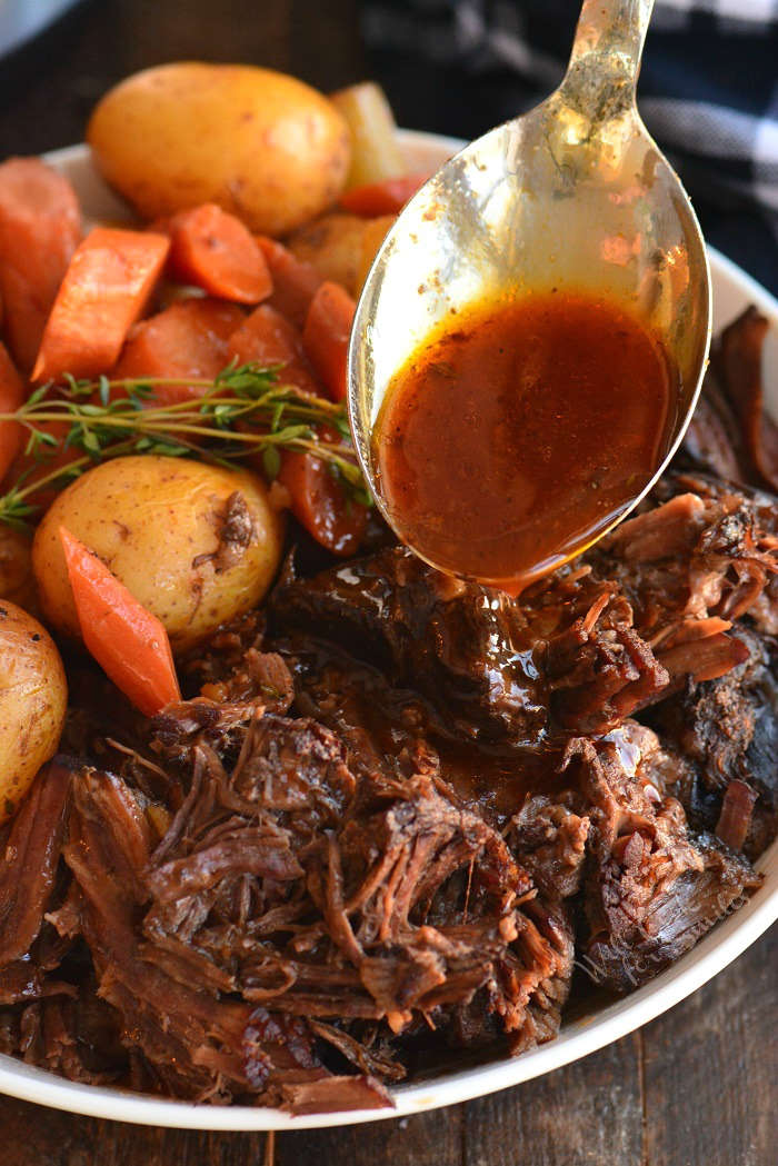 spooning gravy over pot roast