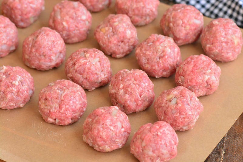 rolled meatballs on parchment paper 
