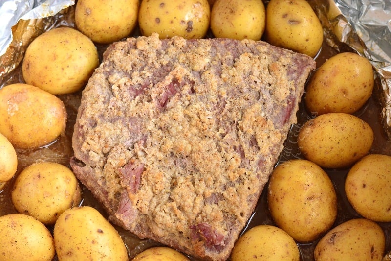 adding potatoes to the roasting pan 