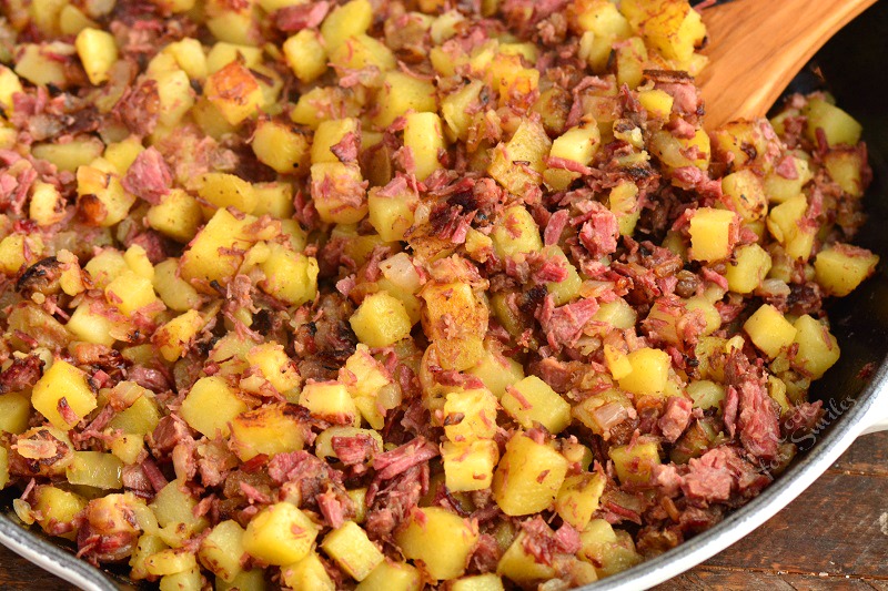 closeup cooked corned beef hash in a skillet.