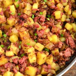 closeup of scooping out corned beef hash and title.