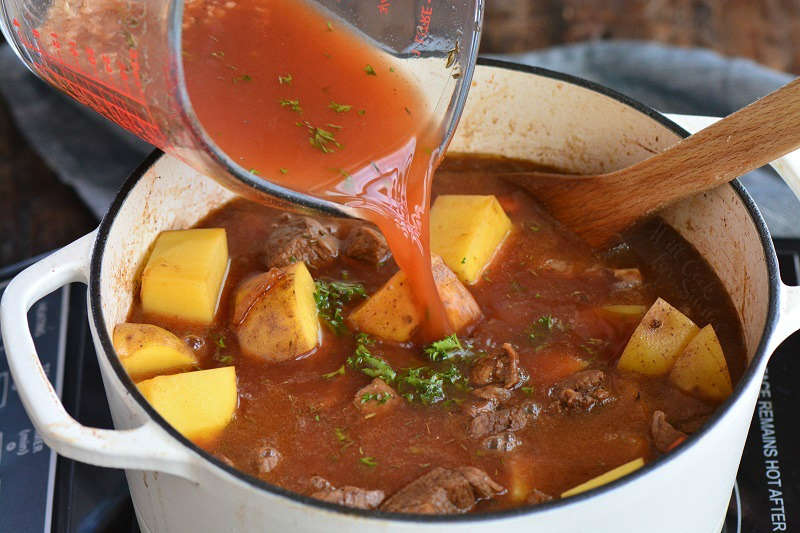 adding beef stock mixture into the pot