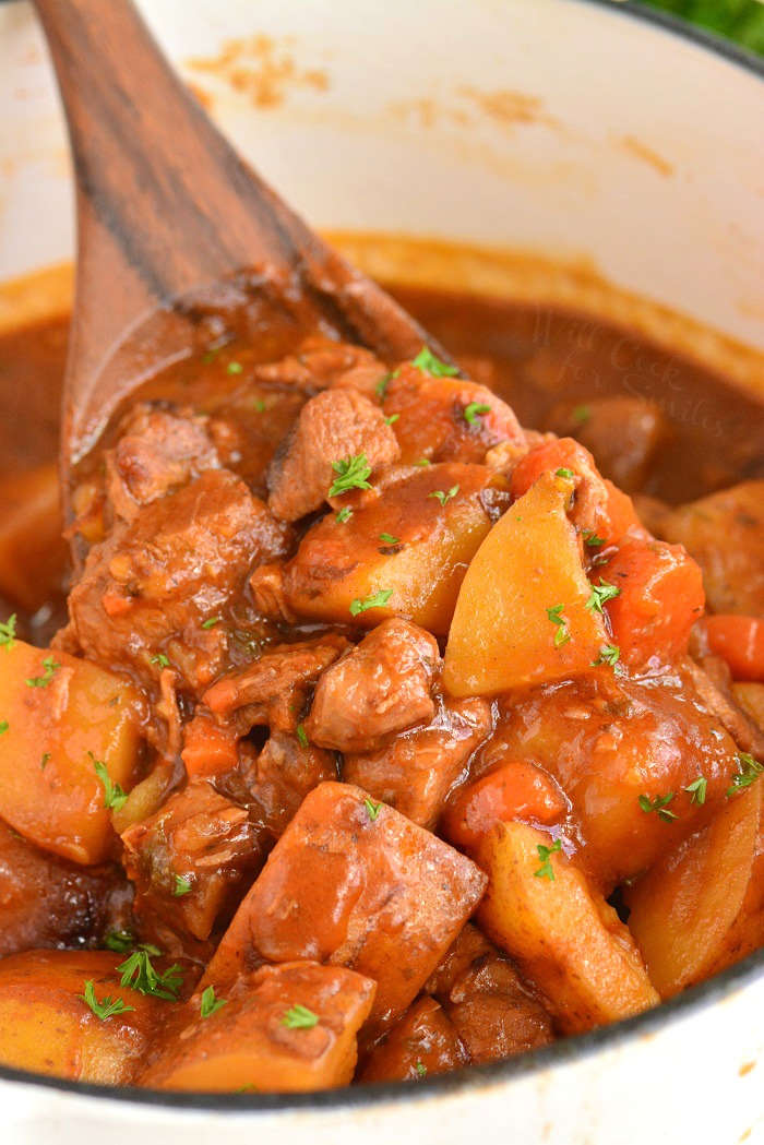 scooping cooked stew