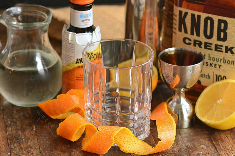 ingredients to make a whiskey sour cocktail side by side .