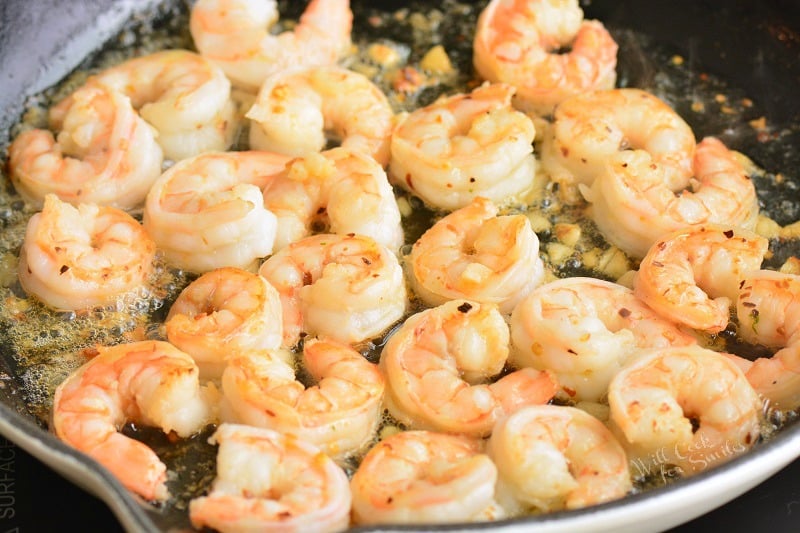 cooking shrimp with garlic and butter in a pan 