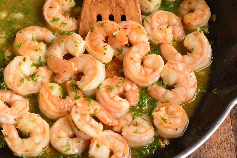 horizontal image of shrimp in the pan with sauce in a pan