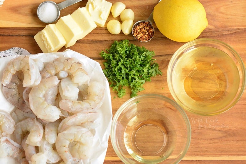 ingredients for shrimp scampi on a wood cutting board 