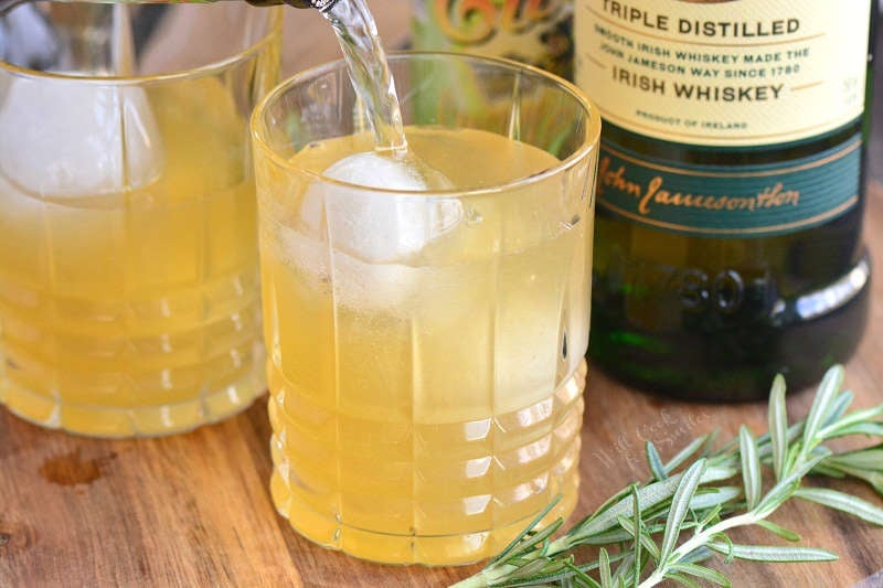 adding ginger beer to the glass cocktail.