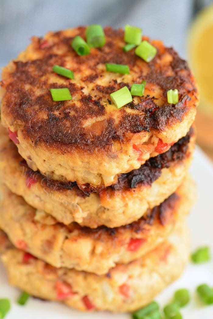 stacked cooked salmon patties with green onion sprinkled on top