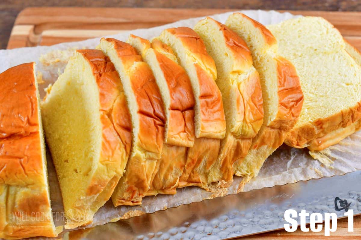 sliced Brioche loaf on the cutting board and knife next to it.