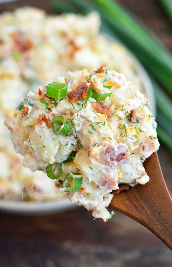 scoop of potato salad on a wooden spoon