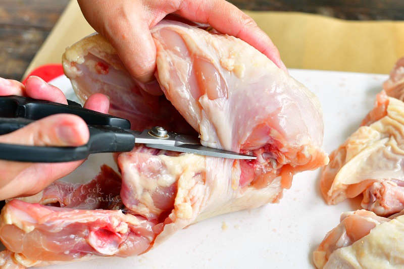 cutting chicken breast from the backbone using kitchen sheers