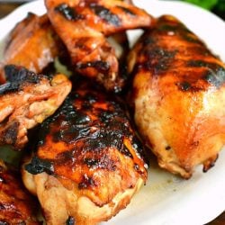 grilled marinated chicken breast wings and legs on a white plate