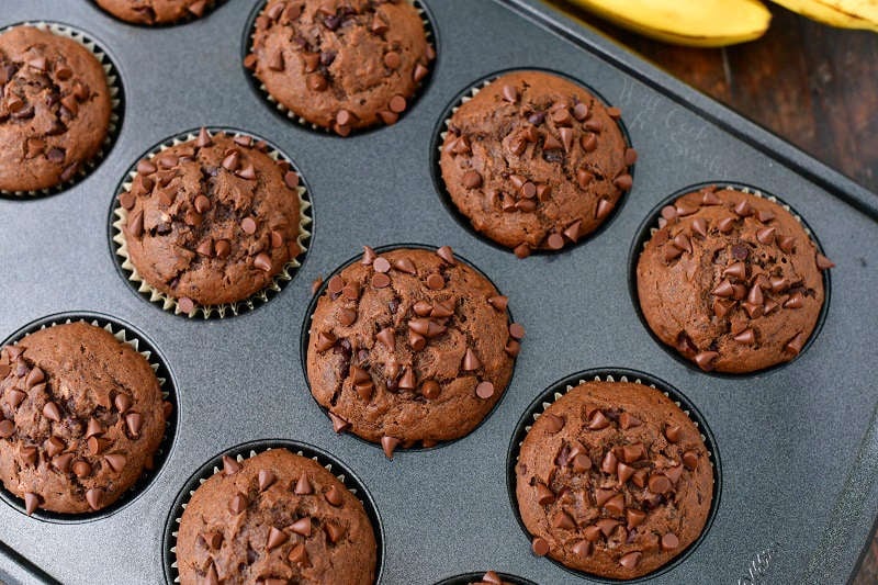 top view of baked chocolate muffins in a metal muffin pan