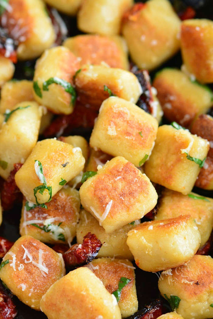 crispy cauliflower gnocchi cooked with sun died tomatoes, basil, and Parmesan cheese