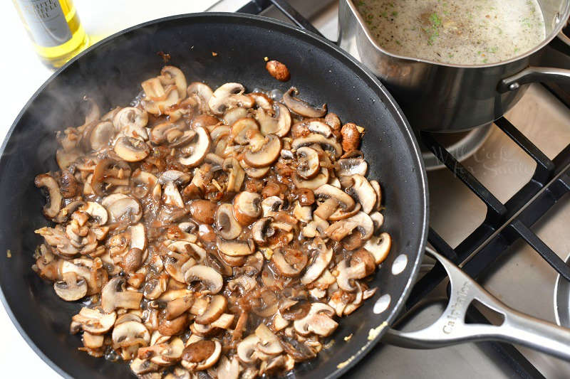 overhead photo: sliced Baby Bella mushrooms cooking in a skillet