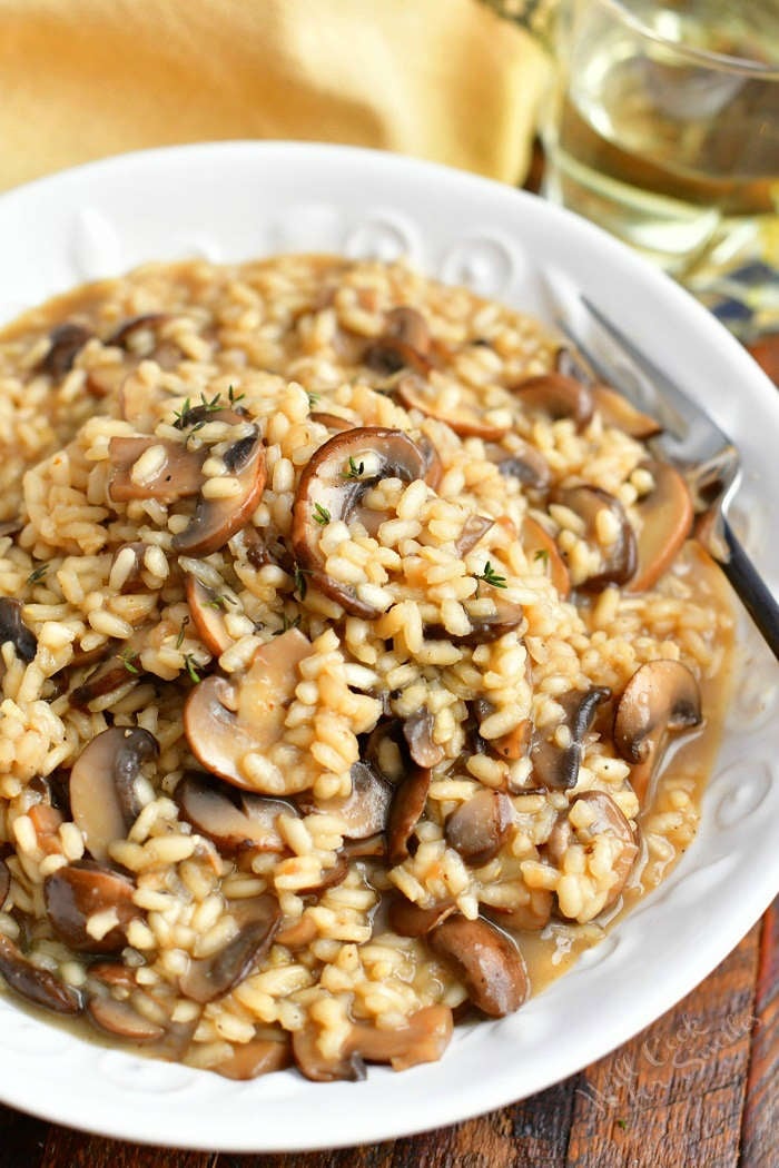 overhead photo: bowl of risotto with truffle oil and mushrooms