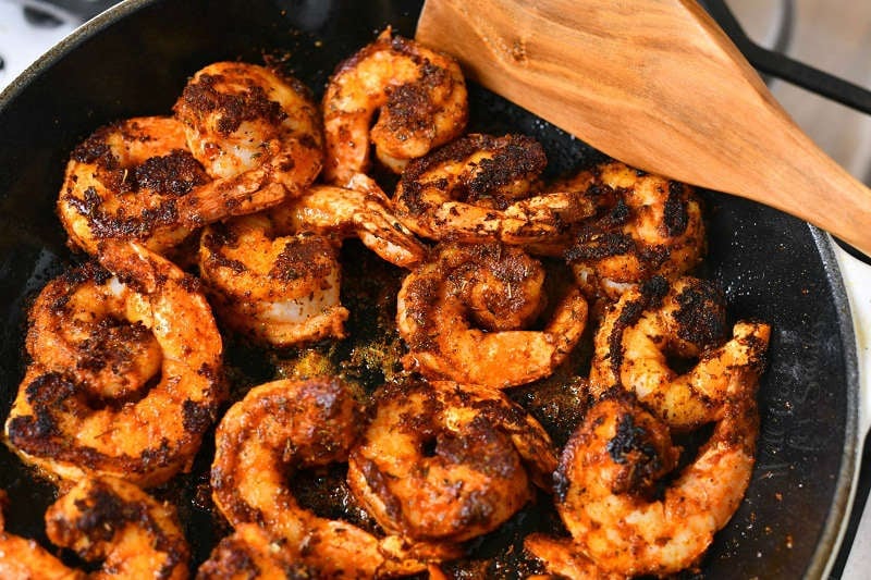 overhead photo: making spicy shrimp recipe in cast iron skillet