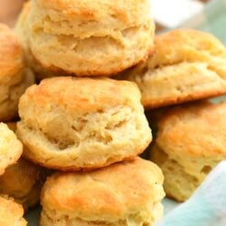 close up photo: cluster of tall, flaky biscuits