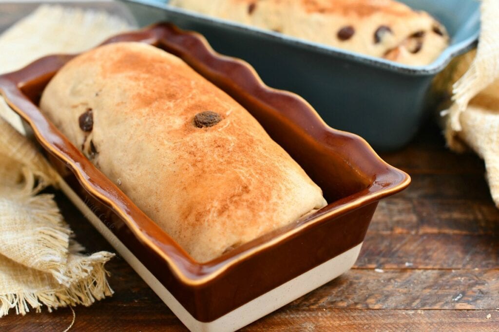 homemade loaf of yeast bread in red glazed stoneware loaf pan