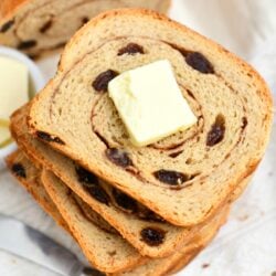 overhead photo: stacked slices of raisin bread - butter on top slice