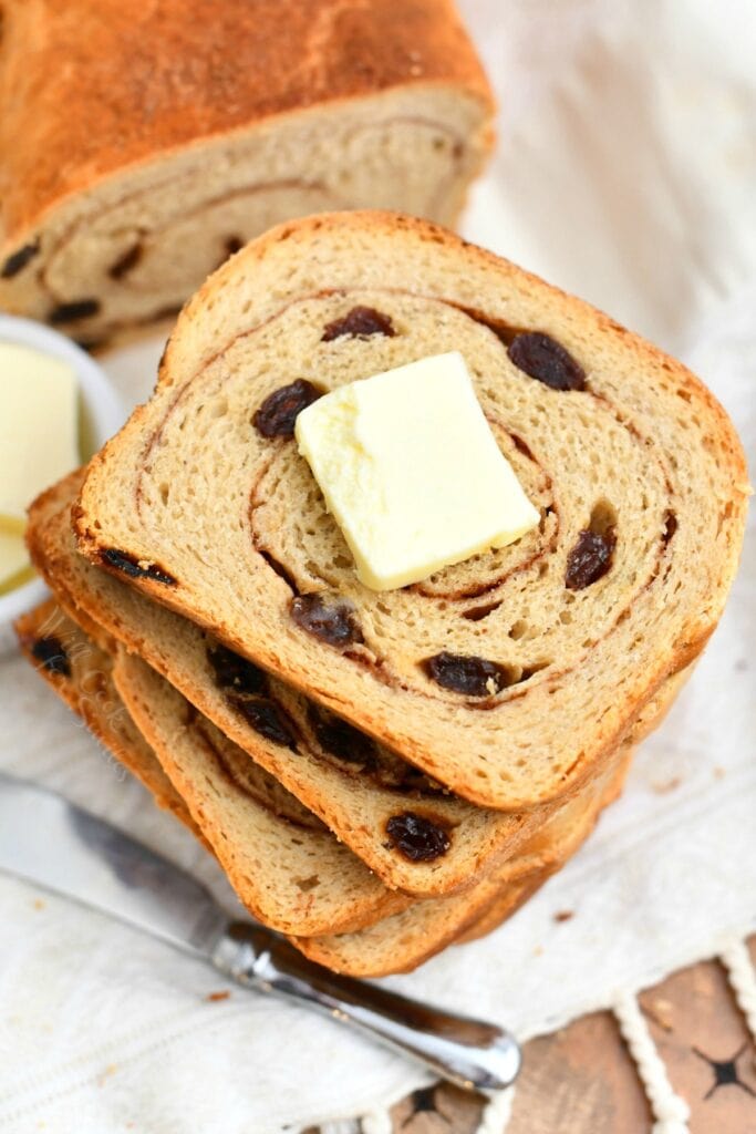 overhead photo: stacked slices of raisin bread - butter on top slice