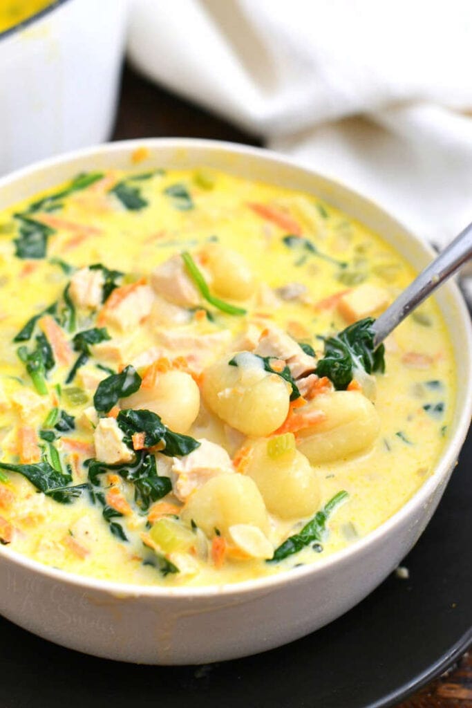 close up: homemade creamy chicken soup with spoon in bowl