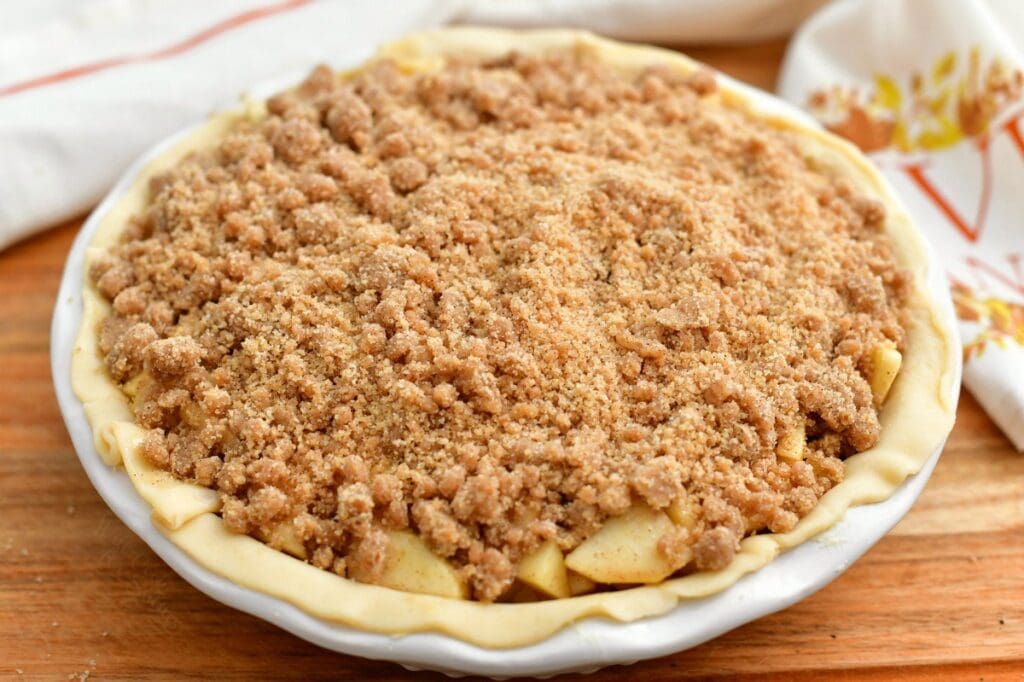 apple pie with crumble topping, ready for baking