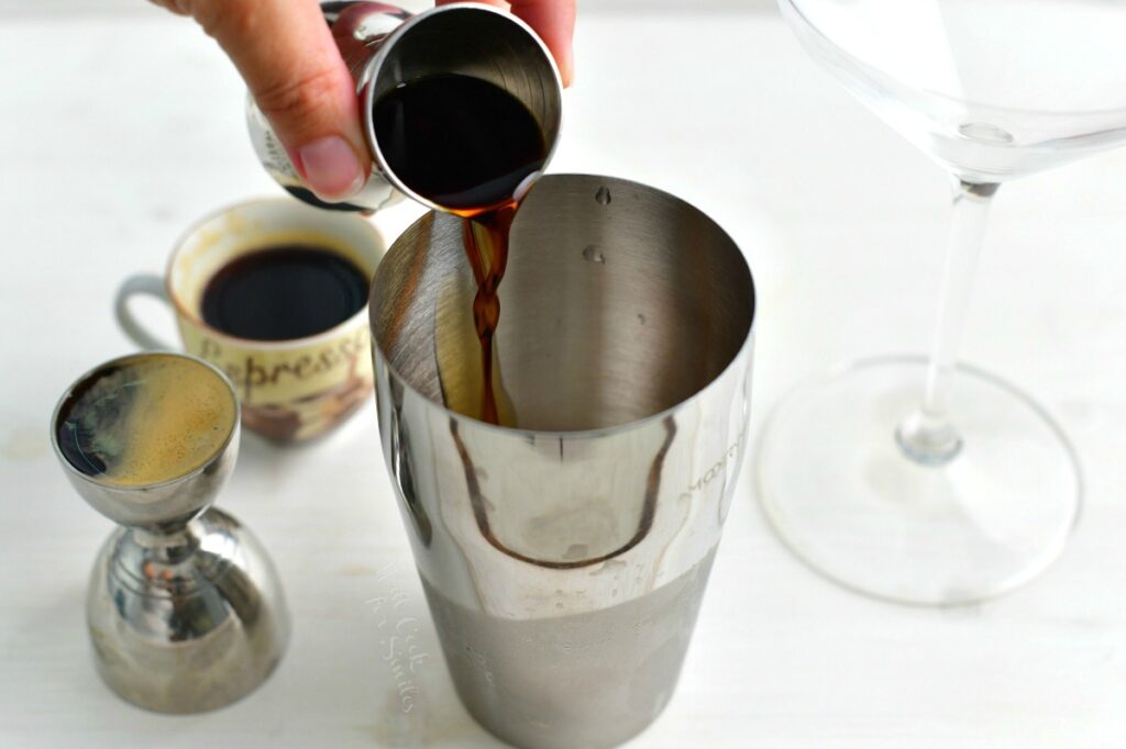 pouring the coffee liqueur into the cocktail shaker