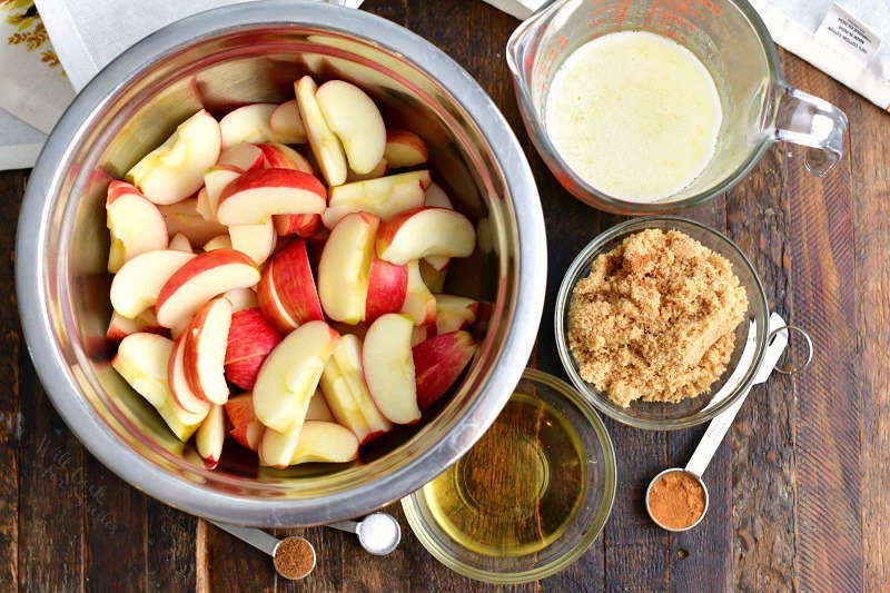 overhead photo: bowl of red apple slices and other ingredients for fried apples recipe