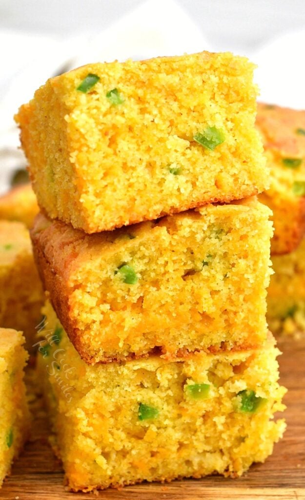 3 stacked squares of cheesy cornbread with green chili peppers