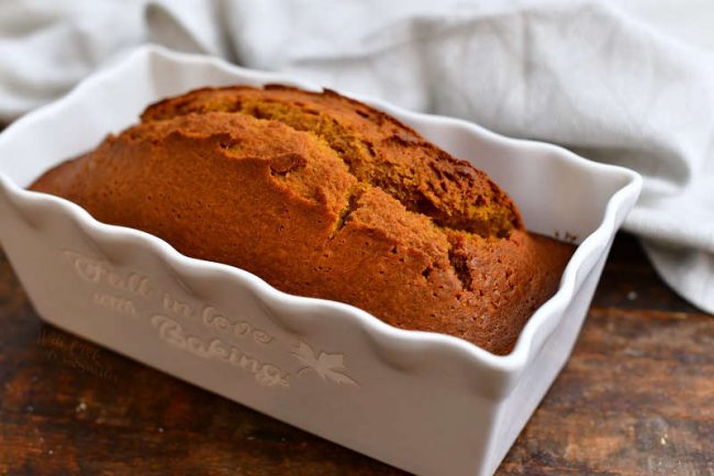 loaf of homemade bread in white ceramic loaf pan
