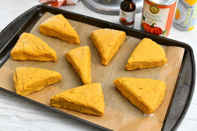 unbaked pumpkin scones on parchment lined baking sheet