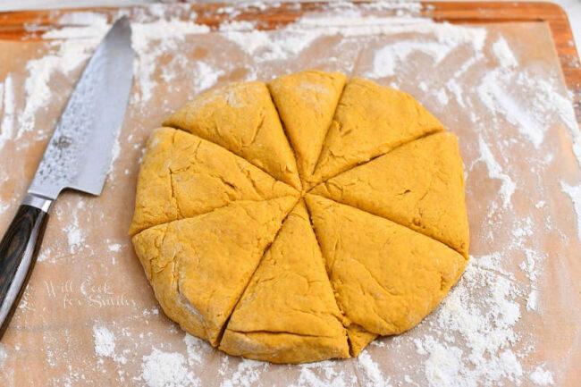 cutting pumpkin dough into triangles for a scone recipe