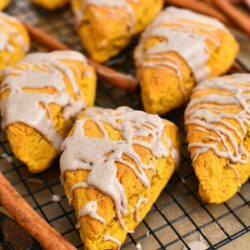 glazed pumpkin scones on black wire cooling rack