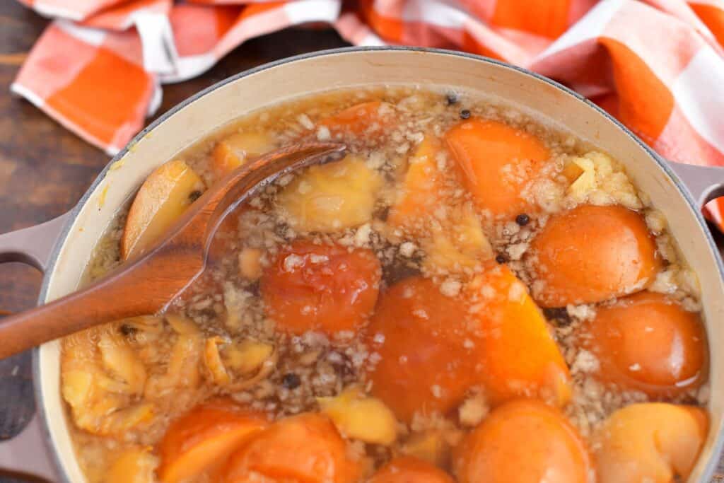 making homemade apple cider in pot on stove top