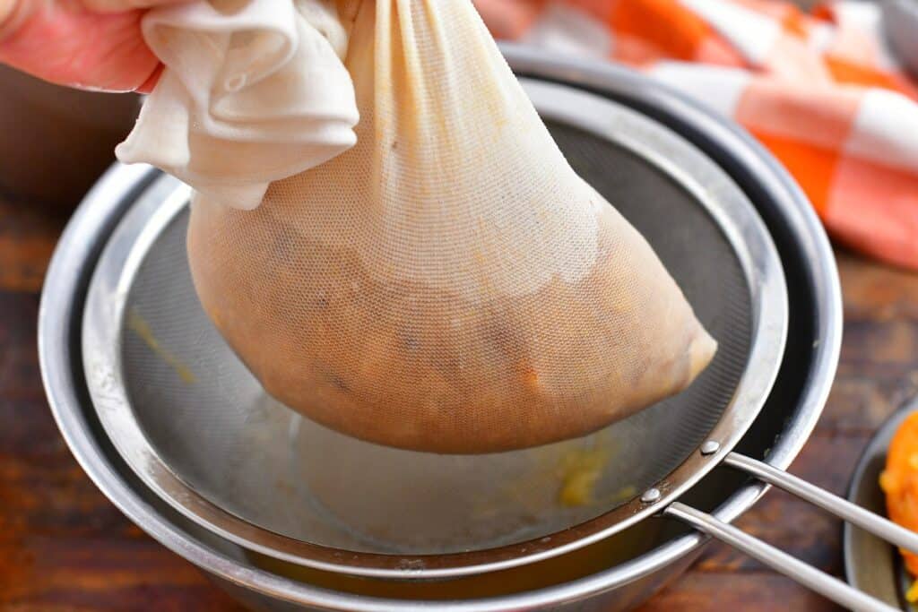 mashing apples in cheesecloth to make cider