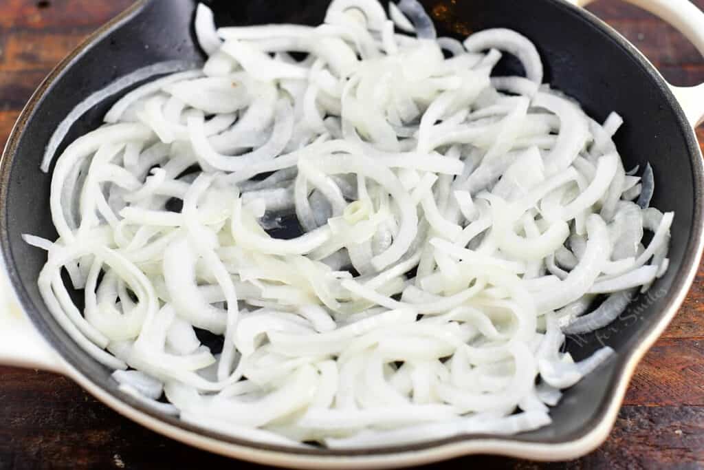 cooking sliced onions in a skillet