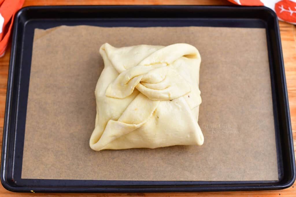 brie cheese wrapped inside of puff pastry, ready for baking