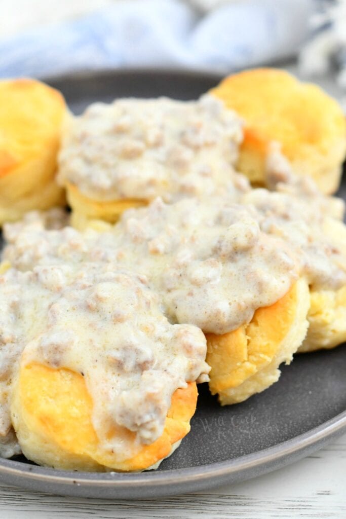 golden biscuits covered in white sausage gravy