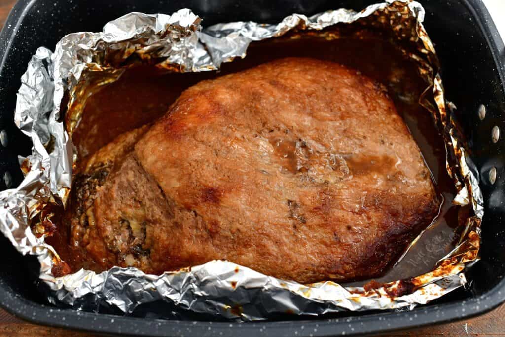 overhead photo: roasting pan of large brisket in the oven