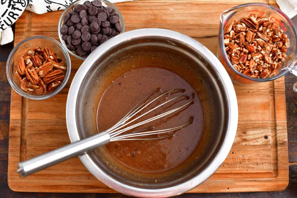 ingredients in bowls on cutting board to make chocolate pecan pie recipe