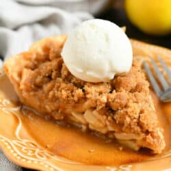 closeup of a slice of apple pie with crumble topping and ice cream