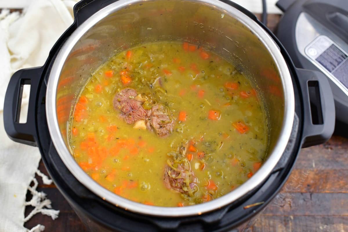 cooked pea soup in the pressure cooker with lid taken off.