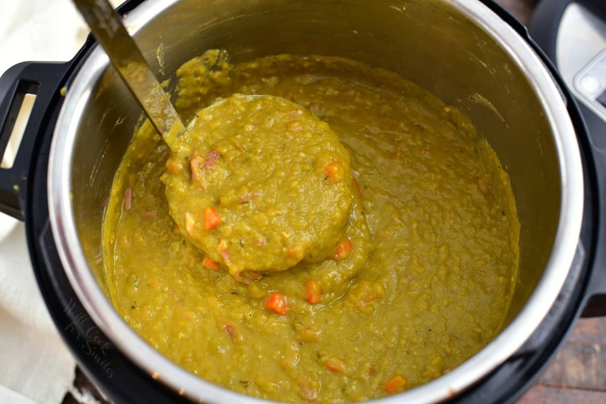 pulling out a ladle full of thick pea soup in an Instant Pot.