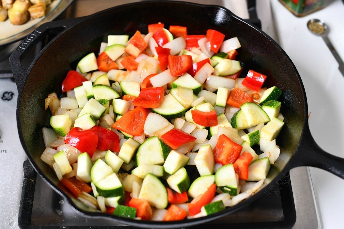 raw chopped garden vegetables in cast iron pan